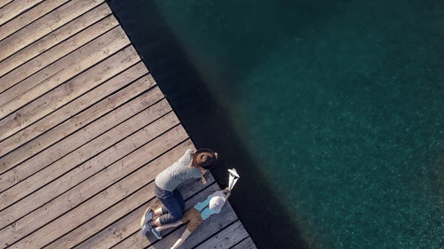 Mother and son playing with toy boat